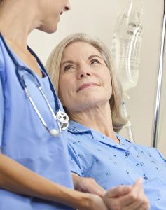 Senior Female Patient In Hospital Bed & Doctor